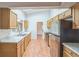 Well-lit kitchen with stainless steel appliances, light countertops, and wood cabinets at 111 Tarrytown Trl, Longwood, FL 32750
