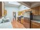 Bright kitchen featuring a skylight, stainless steel appliances, light countertops, and wood cabinets at 111 Tarrytown Trl, Longwood, FL 32750