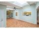 Bright sun room featuring a skylight, tile floors, and a stone accent wall and seating at 111 Tarrytown Trl, Longwood, FL 32750
