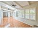 Spacious sunroom boasts beamed ceilings, large windows with shutters and tile flooring at 111 Tarrytown Trl, Longwood, FL 32750