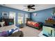 Blue bedroom with twin beds, ceiling fan, and bright natural light at 1112 Spruce Ridge Ct, Minneola, FL 34715