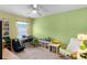 Bright bedroom with green walls, a ceiling fan, a desk, and playful decor for a  at 1112 Spruce Ridge Ct, Minneola, FL 34715