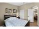 Bedroom featuring a wood floor, neutral walls, with view of the closet and hall at 1112 Spruce Ridge Ct, Minneola, FL 34715