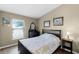 Bedroom with dark furniture, wood floors, natural light from window, and beachy decor at 1112 Spruce Ridge Ct, Minneola, FL 34715