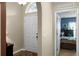 Inviting foyer with a white front door that leads into a bedroom with blue walls at 1112 Spruce Ridge Ct, Minneola, FL 34715