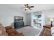 The living room features sliding glass doors to the patio and plush leather seating at 1112 Spruce Ridge Ct, Minneola, FL 34715