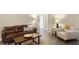 Comfortable living room featuring a leather sofa, area rug, and light-filled interior at 1112 Spruce Ridge Ct, Minneola, FL 34715