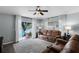 A sunlit living room boasts sliding glass doors to the patio at 1112 Spruce Ridge Ct, Minneola, FL 34715