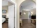 View of the living room with doorway to a bedroom and arched doorways to the kitchen at 1112 Spruce Ridge Ct, Minneola, FL 34715