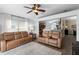 A living room offers lots of seating and an open floor plan into the kitchen at 1112 Spruce Ridge Ct, Minneola, FL 34715