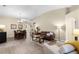 Open-concept living area with dining room, leather sofa, and plenty of natural light at 1112 Spruce Ridge Ct, Minneola, FL 34715