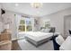 Cozy bedroom featuring a large window, natural light, and stylish modern decor at 1217 Kenwood Ave, Winter Park, FL 32789