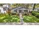 Beautifully landscaped front yard leading to a gray craftsman style home at 1217 Kenwood Ave, Winter Park, FL 32789