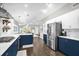 Open kitchen with stainless steel appliances, modern lighting, and views into the living room at 1217 Kenwood Ave, Winter Park, FL 32789