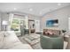 Bright living room with large windows, sleek furniture, and neutral decor at 1217 Kenwood Ave, Winter Park, FL 32789