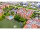 Aerial view of resort condo and community amenities, including a pool, lake and fountain at 12527 Floridays Resort Dr # E104, Orlando, FL 32821