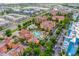 Gorgeous aerial view of a multi-building condo community with a pool, landscaping, and nearby lake at 12527 Floridays Resort Dr # E104, Orlando, FL 32821