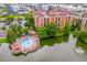 Aerial view of a building with a pool and waterfront views, perfect for a relaxing lifestyle at 12527 Floridays Resort Dr # E104, Orlando, FL 32821