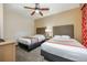 Comfortable bedroom featuring two beds with grey headboards and a ceiling fan at 12527 Floridays Resort Dr # E104, Orlando, FL 32821
