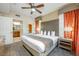 Comfortable bedroom featuring a king-sized bed with an ensuite bathroom and a ceiling fan at 12527 Floridays Resort Dr # E104, Orlando, FL 32821