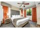Comfortable bedroom featuring a king-sized bed, a ceiling fan and large windows with natural light at 12527 Floridays Resort Dr # E104, Orlando, FL 32821