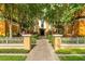 Inviting entrance with landscaped walkway and decorative fencing, leading to a charming and well-maintained building at 12527 Floridays Resort Dr # E104, Orlando, FL 32821