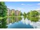 View of the community's exterior featuring a pond, fountain, and lush green landscaping at 12527 Floridays Resort Dr # E104, Orlando, FL 32821