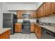 Kitchen with stainless steel appliances, stone countertops, and tiled flooring at 12527 Floridays Resort Dr # E104, Orlando, FL 32821