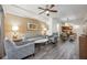 Comfortable living room with ceiling fan, artwork and access to kitchen and dining area at 12527 Floridays Resort Dr # E104, Orlando, FL 32821