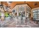 Charming outdoor bar area with stools, televisions, and tiled floors, perfect for entertaining and relaxation at 12527 Floridays Resort Dr # E104, Orlando, FL 32821