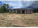 Expansive backyard featuring the new construction home with a partially covered back porch perfect for entertaining at 12756 Sw 80 St, Dunnellon, FL 34432