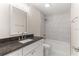 Granite vanity in the bathroom with neutral tile and bath and shower combo at 12756 Sw 80 St, Dunnellon, FL 34432