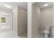 Bathroom featuring tiled shower, toilet, and entrance to bedroom at 12756 Sw 80 St, Dunnellon, FL 34432
