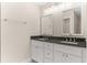 Bathroom featuring double vanity with granite countertop, white cabinets, and brushed nickel hardware at 12756 Sw 80 St, Dunnellon, FL 34432