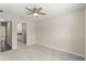 Spacious bedroom with neutral carpet and paint and a ceiling fan at 12756 Sw 80 St, Dunnellon, FL 34432