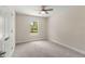 Well lit bedroom showcasing a ceiling fan and a large view window at 12756 Sw 80 St, Dunnellon, FL 34432