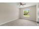 Bright bedroom featuring a large window overlooking a lush green lawn at 12756 Sw 80 St, Dunnellon, FL 34432