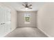 Bedroom with carpet flooring, ceiling fan, and natural light at 12756 Sw 80 St, Dunnellon, FL 34432