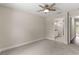 Bedroom featuring ceiling fan, carpet flooring, and entrance to bathroom at 12756 Sw 80 St, Dunnellon, FL 34432