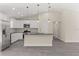 Bright kitchen with white cabinets, stainless steel appliances, and a center island at 12756 Sw 80 St, Dunnellon, FL 34432