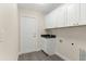 Functional laundry room with cabinets and granite sink at 12756 Sw 80 St, Dunnellon, FL 34432