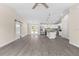Open living space with gray flooring, sliding barn door, stainless steel appliances, and modern lighting fixtures at 12756 Sw 80 St, Dunnellon, FL 34432