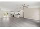Open living space with gray flooring, sliding barn door, stainless steel appliances, and modern lighting fixtures at 12756 Sw 80 St, Dunnellon, FL 34432