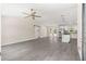 Open living space with gray flooring, sliding barn door, stainless steel appliances, and modern lighting fixtures at 12756 Sw 80 St, Dunnellon, FL 34432