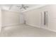 Large main bedroom with neutral decor, tray ceiling, and multiple doorways at 12756 Sw 80 St, Dunnellon, FL 34432