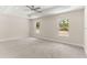Bright main bedroom with a ceiling fan, two windows, and neutral carpeting at 12756 Sw 80 St, Dunnellon, FL 34432
