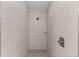 Inside the tiled shower stall with a shower head, small shelf, and stone floor at 12756 Sw 80 St, Dunnellon, FL 34432