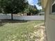 Spacious backyard with a well-maintained lawn and a white vinyl fence at 13000 Sandy Pine Ln, Clermont, FL 34711