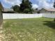 Large, grassy backyard enclosed by a pristine white vinyl fence at 13000 Sandy Pine Ln, Clermont, FL 34711
