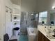 Bright bathroom featuring a tiled shower-tub combo, vanity with sink, and closet space at 13000 Sandy Pine Ln, Clermont, FL 34711